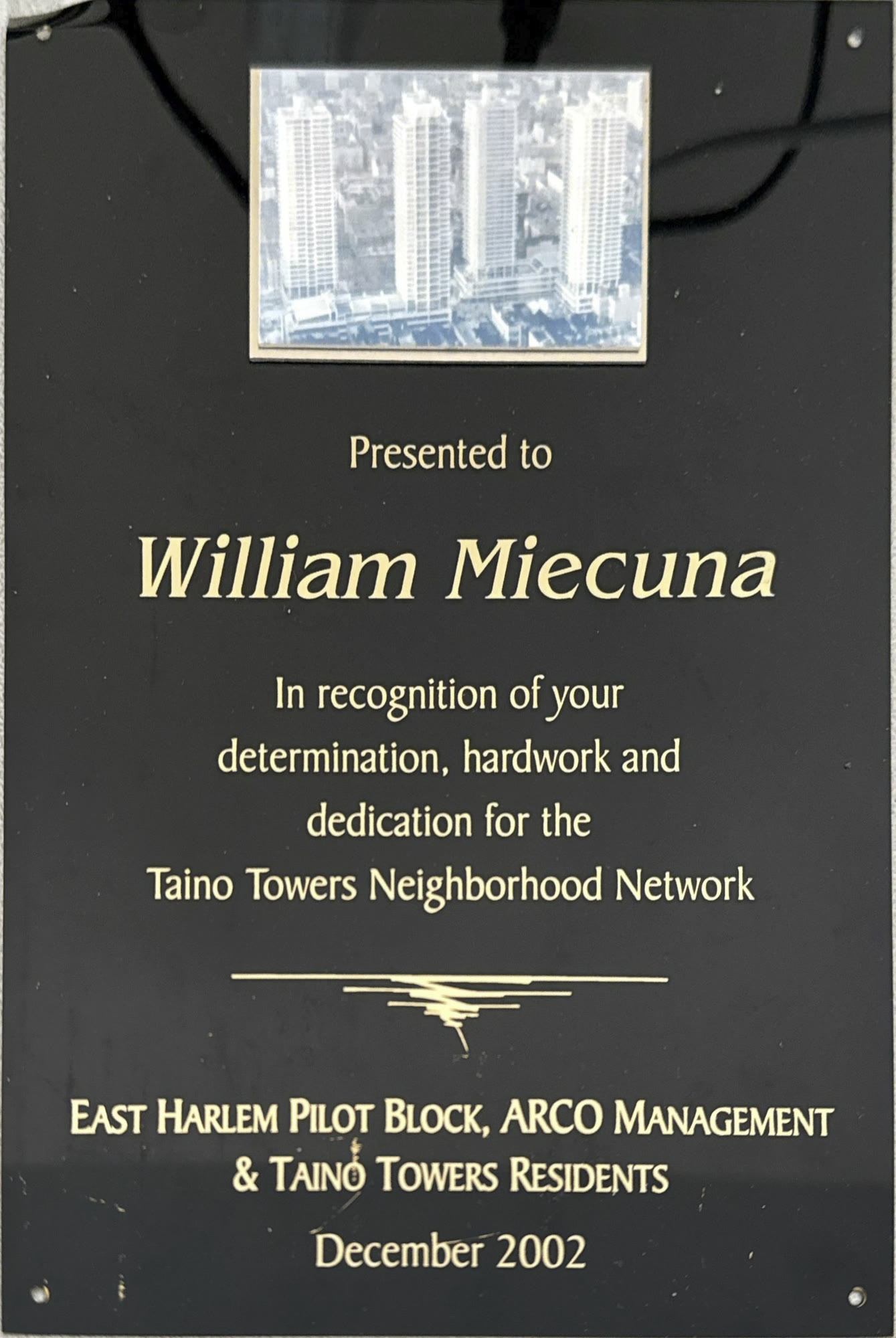 Black plaque from the Taino Towers Neighborhood Network, December 2002